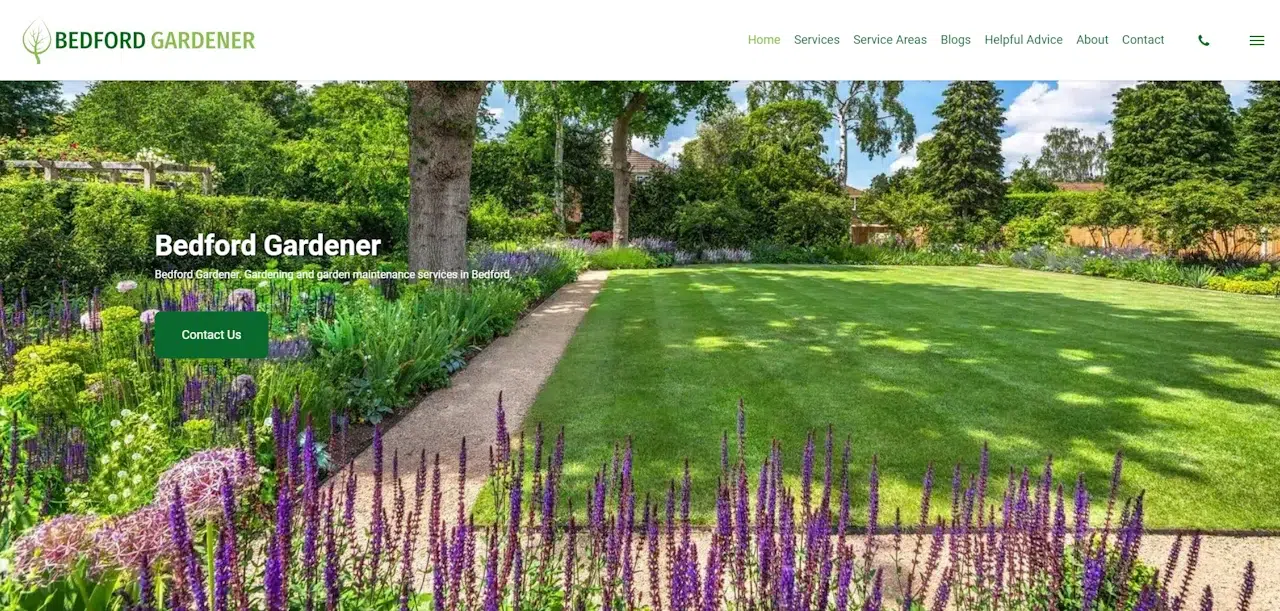 A vibrant garden with a lush green lawn and colorful flower beds is shown, framed by tall trees and bushes. The website banner proudly reads "Bedford Gardener," with additional text and a green button labeled "Contact Us" visible on the left side.
